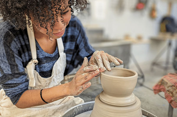 Student creating pottery
